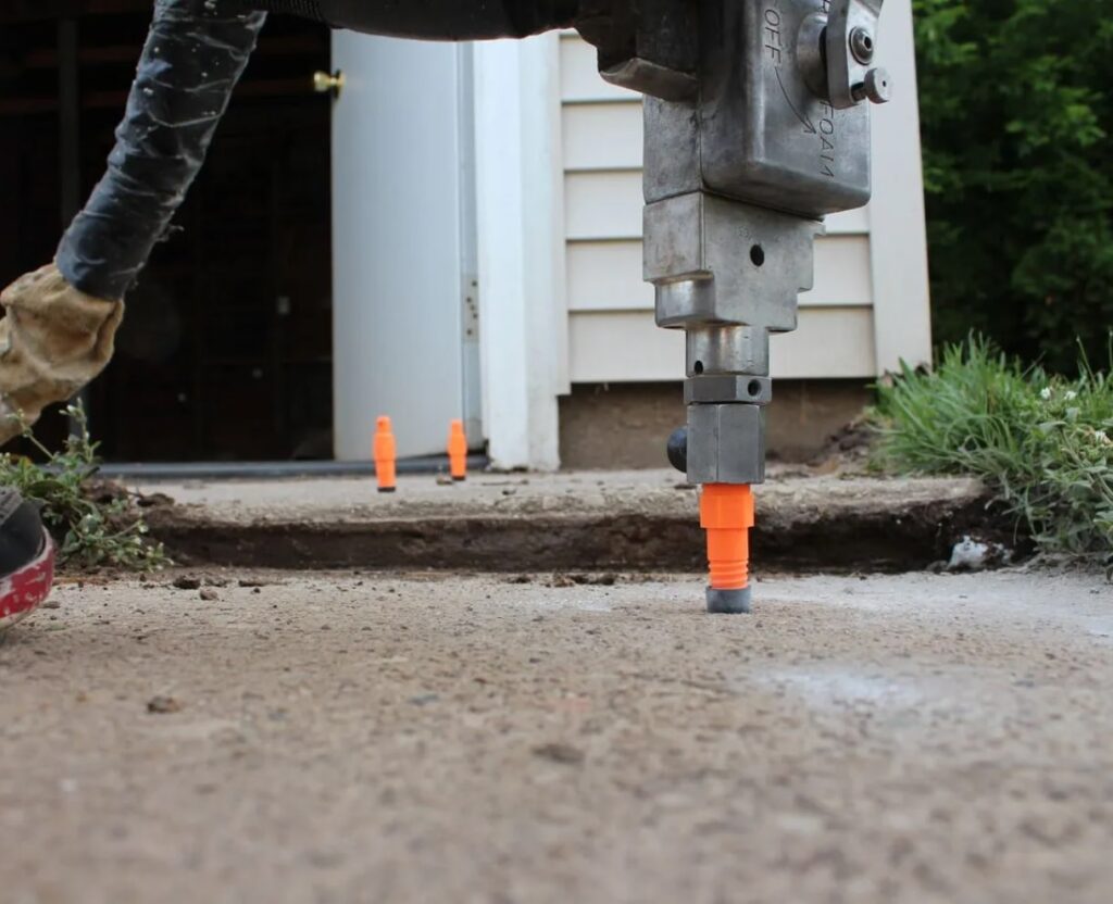 Concrete raising and levelling: injection at garage slab, cones