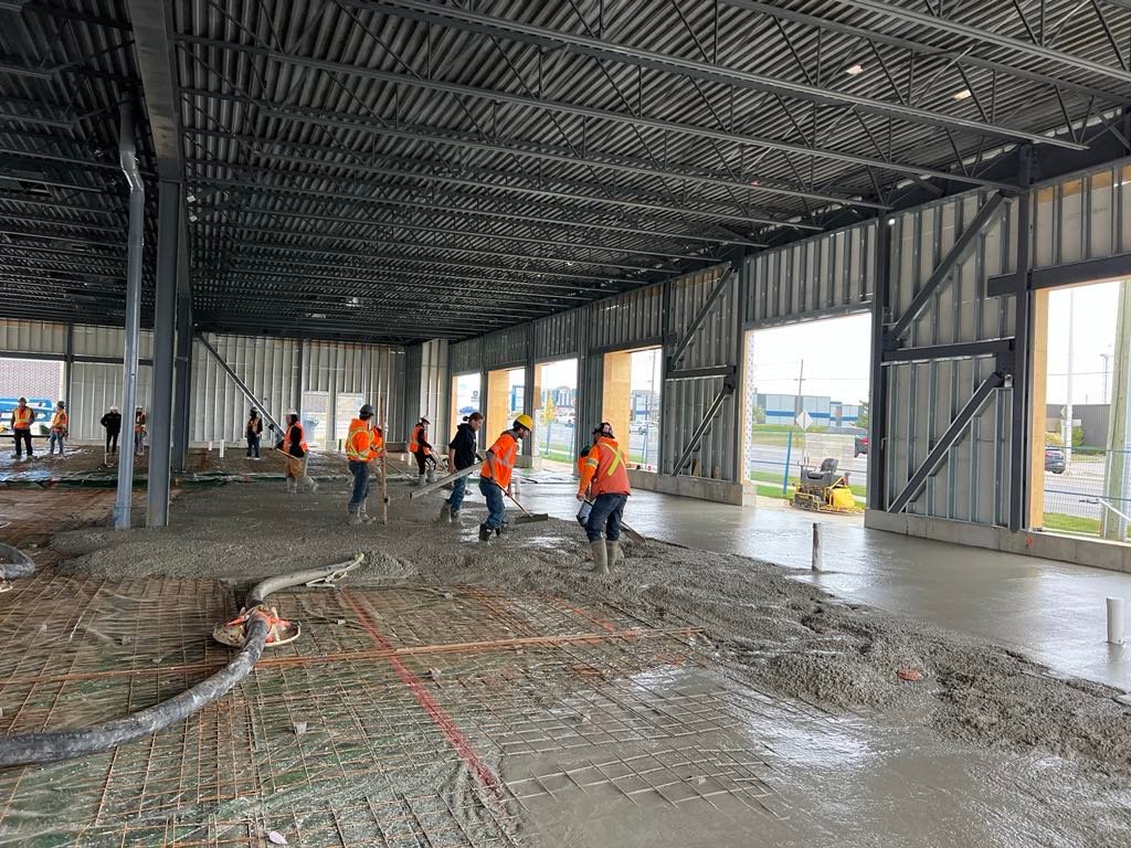 Commercial concrete placing and finishing: steel building interior, fresh slab