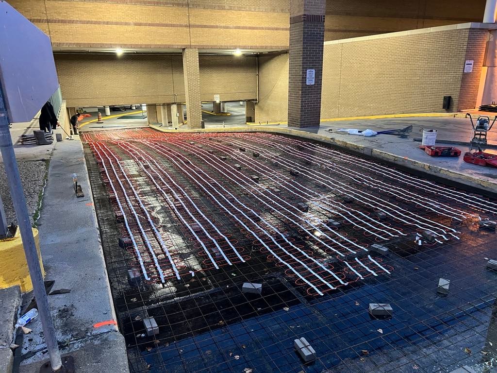 Commercial concrete placing and finishing: heated tubing and rebar on slab