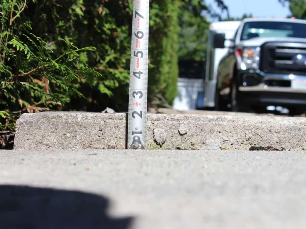 Concrete raising and levelling: tape measure at slab edge