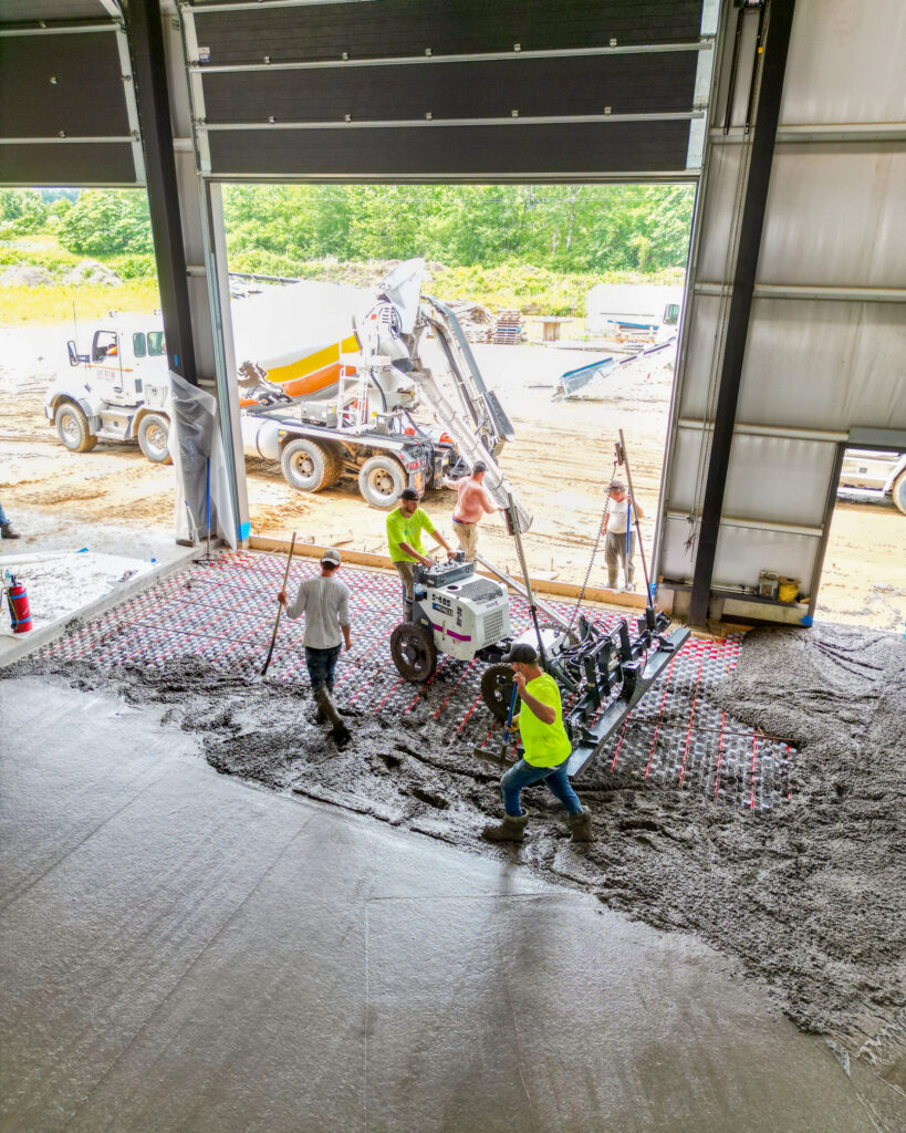 Brosco Concrete crew placing concrete inside a steel-frame building