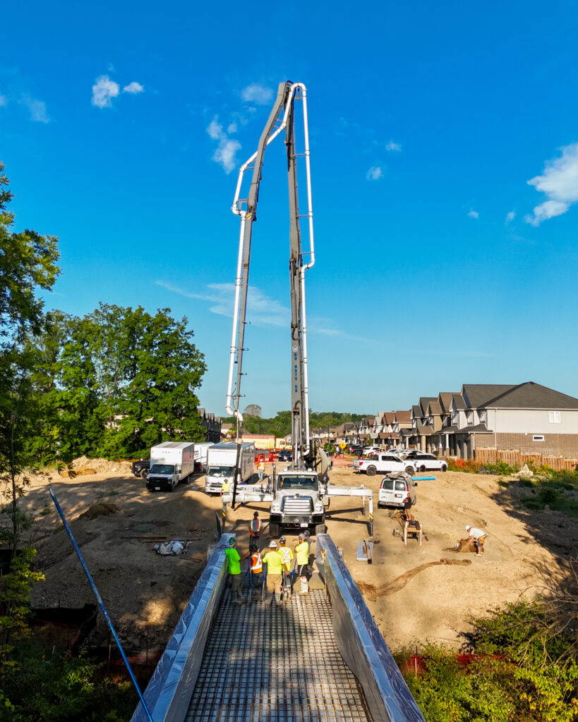 Concrete pump truck placing a large-scale commercial slab