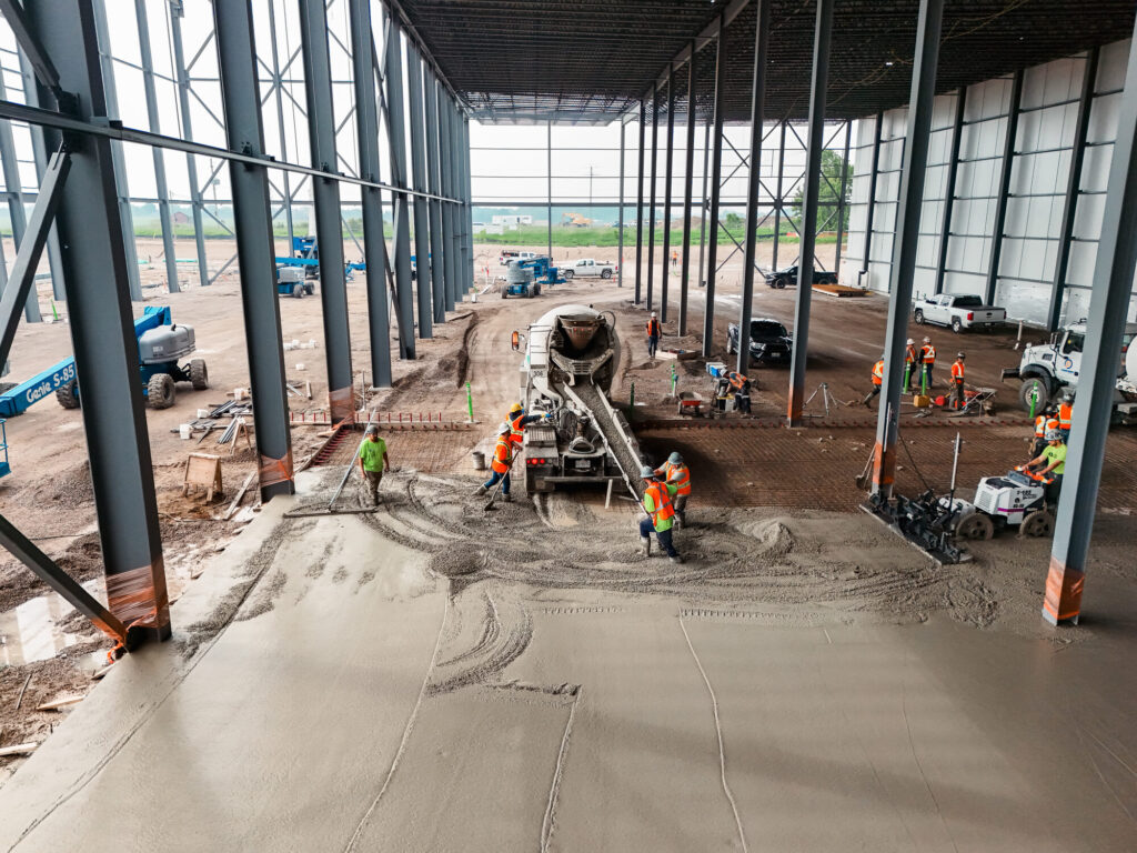 Concrete truck placing a large commercial slab with the Brosco crew