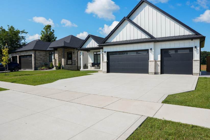 New concrete driveway at a three-car garage