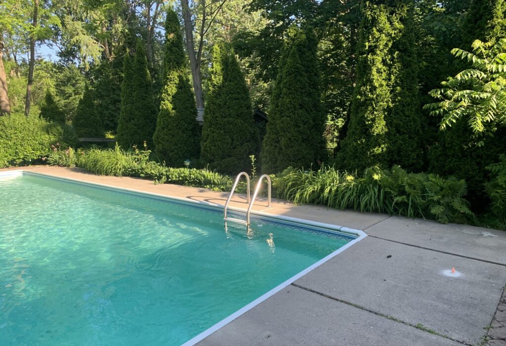 Settled concrete pool deck before raising and levelling