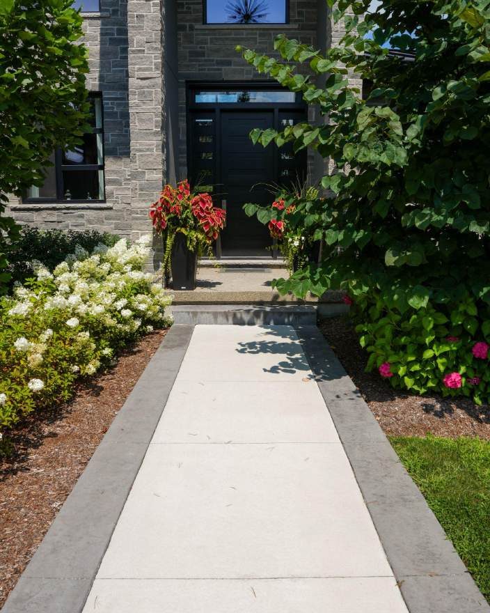 Broom finish concrete walkway with Old Granite border